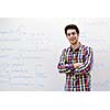 happy young teenage boy portrait in school on chemistry classes and library