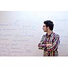 happy young teenage boy portrait in school on chemistry classes and library