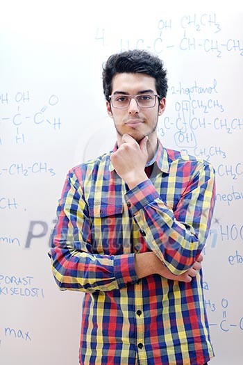happy young teenage boy portrait in school on chemistry classes and library happy young teenage boy portrait in school on chemistry classes and library