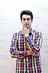 happy young teenage boy portrait in school on chemistry classes and library