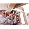 father and son assembling airplane toy at modern home living room indoor