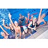 group of happy kids children   at swimming pool class  learning to swim