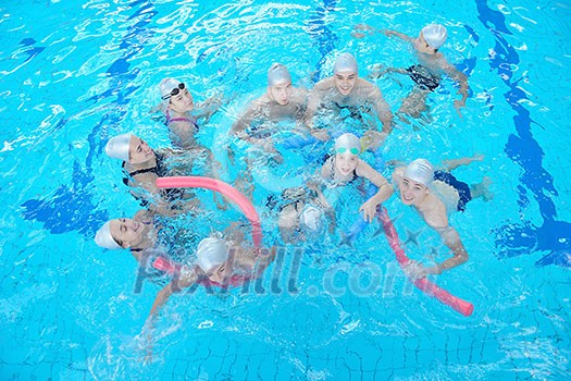 group of happy kids children at swimming pool class learning to swim group of happy kids children at swimming pool class learning to swim