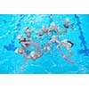 group of happy kids children   at swimming pool class  learning to swim