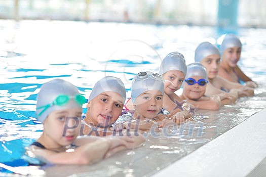 group of happy kids children at swimming pool class learning to swim group of happy kids children at swimming pool class learning to swim