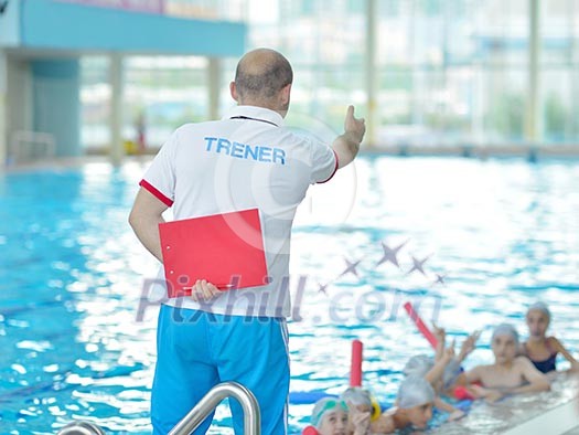 group of happy kids children at swimming pool class learning to swim group of happy kids children at swimming pool class learning to swim