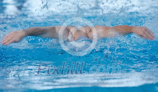 health and fitness lifestyle concept with young athlete swimmer recreating on indoor olimpic pool health and fitness lifestyle concept with young athlete swimmer recreating on indoor olimpic pool