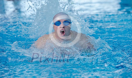 health and fitness lifestyle concept with young athlete swimmer recreating on indoor olimpic pool health and fitness lifestyle concept with young athlete swimmer recreating on indoor olimpic pool
