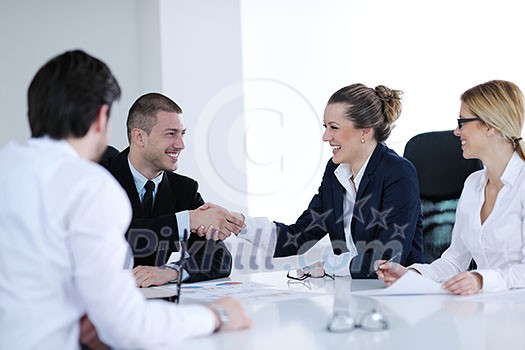 Group of happy young business people in a meeting at office Group of happy young business people in a meeting at office