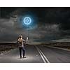 Rear view of woman in casual holding balloon in hand