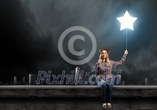 Young woman in casual with balloon shaped like star Young woman in casual with balloon shaped like star