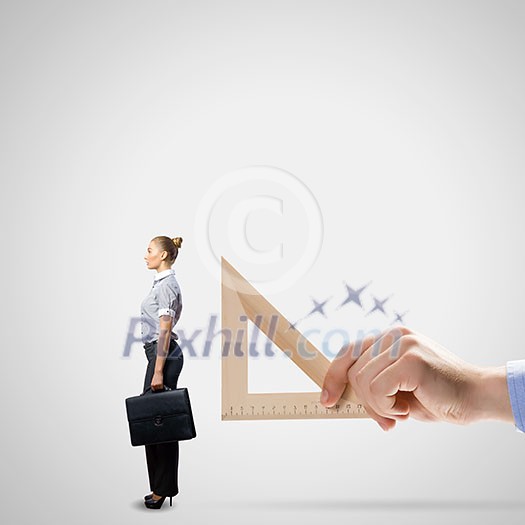 Businessman measuring miniature of business lady with ruler Businessman measuring miniature of business lady with ruler