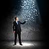 Young woman in suit catching letters falling from above