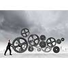Young determined businessman making gear mechanism move