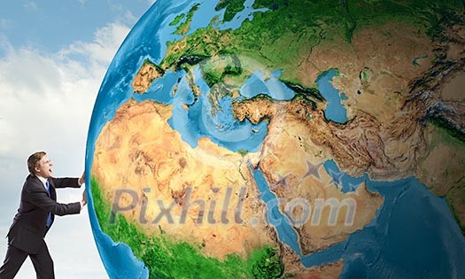 Businessman pushing big Earth planet. Elements of this image are furnished by NASA Businessman pushing big Earth planet. Elements of this image are furnished by NASA