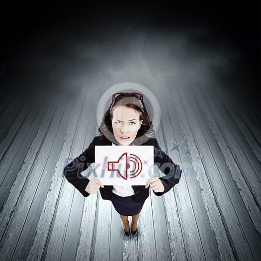 Young businesswoman holding banner with sound sign