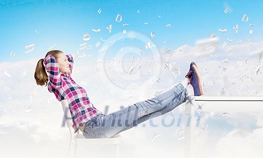 Young woman in casual with legs on table Young woman in casual with legs on table
