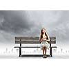 Young pretty asian woman sitting on bench and reading book