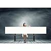 Young asian woman sitting on bench with blank banner