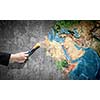 Close up of hand painting Earth planet with brush. Elements of this image are furnished by NASA