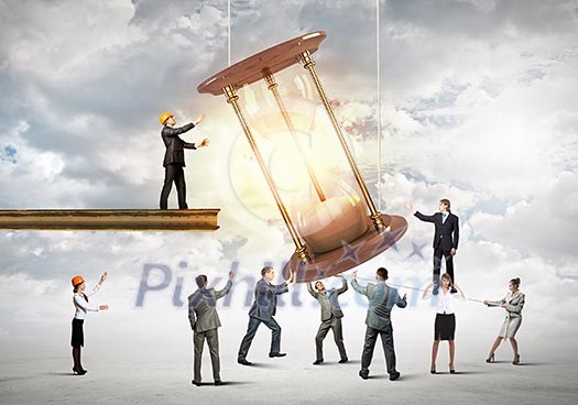 Conceptual image of business people looking at sandglass