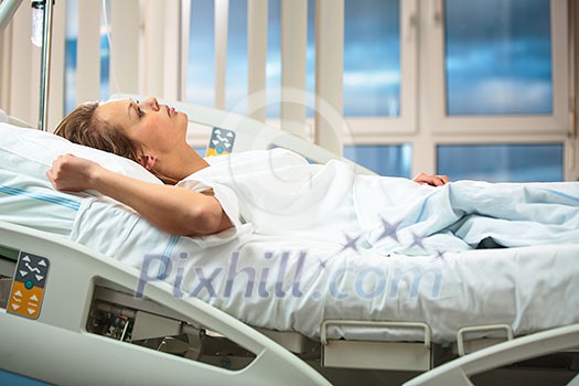 Pretty, young, female patient in a modern hospital room. Getting better fast after a surgery - pensive yet positive, thinking ahead, making plans (shallow DOF; color toned image) Pretty, young, female patient in a modern hospital room. Getting better fast after a surgery - pensive yet positive, thinking ahead, making plans (shallow DOF; color toned image)