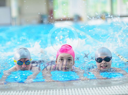 group of happy kids children at swimming pool class learning to swim group of happy kids children at swimming pool class learning to swim
