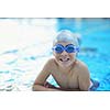 group of happy kids children   at swimming pool class  learning to swim