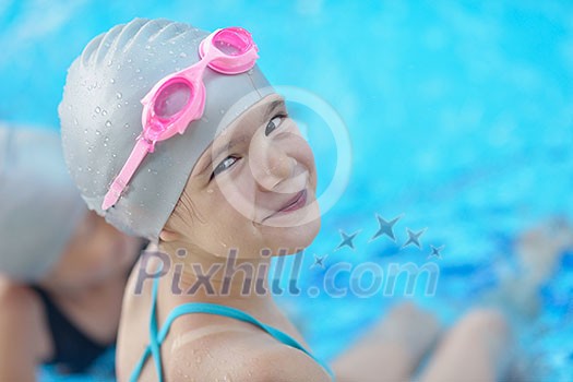 happy little child portrait on swimming school classes and recreation at indoor pool