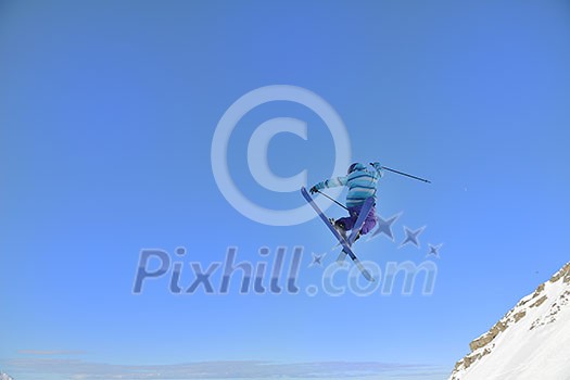 jumping freestyle skier at mountain with fresh snow fresh sunny winter day jumping freestyle skier at mountain with fresh snow fresh sunny winter day