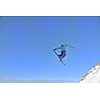jumping freestyle skier at mountain with fresh snow fresh sunny winter day