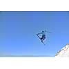 jumping freestyle skier at mountain with fresh snow fresh sunny winter day