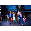 Group Of Friends Enjoying Shopping Trip Together
group of happy young frineds enjoying shopping night and walking on steet on night in with mall in background