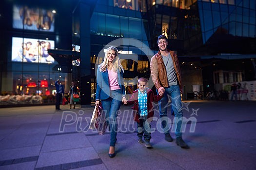 happy family walking with paper bag in front of shopping mall happy family walking with paper bag in front of shopping mall
