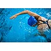 Female swimmer in an indoor swimming pool - doing crawl (shallow DOF)