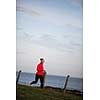 Young woman on her evening jog along the seacoast