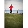 Young woman on her evening jog along the seacoast
