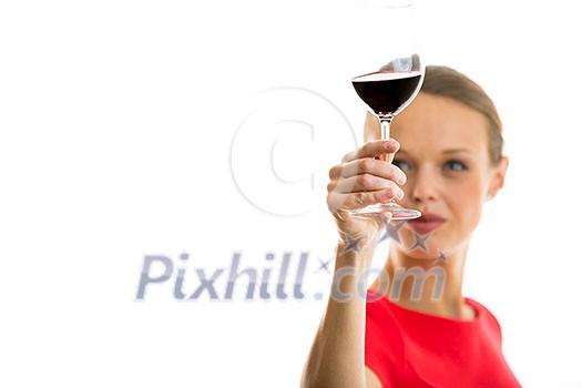 Elegant young woman in a red dress, having a glass of red wine isolated on white background Elegant young woman in a red dress, having a glass of red wine isolated on white background
