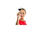 Elegant young woman in a red dress, having a glass of red wine isolated on white background