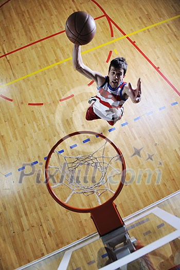 young healthy man play basketball game indoor in gym young healthy man play basketball game indoor in gym