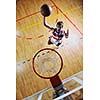young healthy man play basketball game indoor in gym