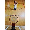basketball game playeer shooting on basket indoor in gym