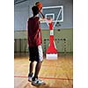 basketball game playeer shooting on basket indoor in gym