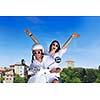 Portrait of happy young love couple on scooter enjoying themselves in a park at summer time