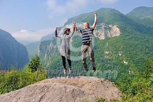 happy young couple in love jump in air in beautiful green and fresh nature happy young couple in love jump in air in beautiful green and fresh nature