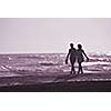 romantic couple walking on beach