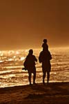 young family walking on beach