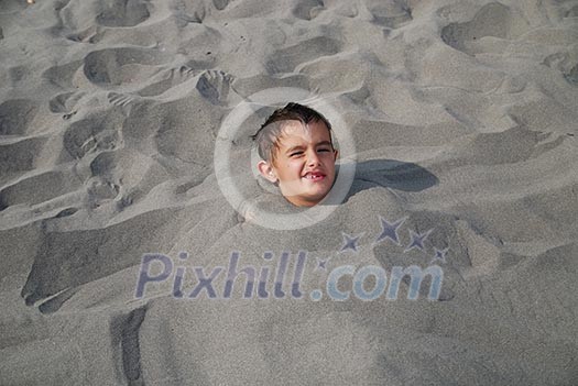 happy children buried in sand happy children buried in sand
