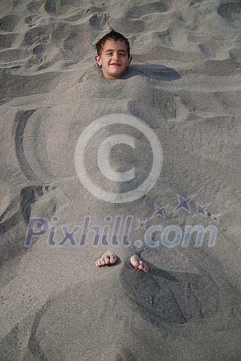 happy children buried in sand happy children buried in sand