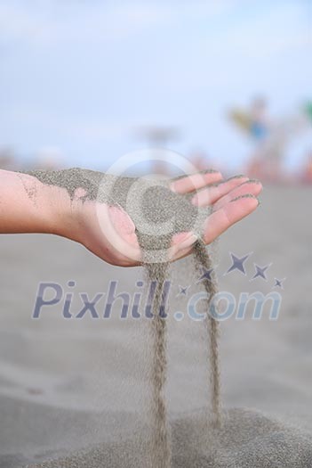 fine sand leaking trought woman hands fine sand leaking trought woman hands